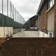 Houses that back onto a Peace Wall on Bombay Street have large cages to protect from flying debris.